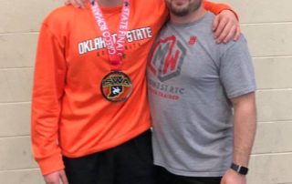 Midwest Wrestling Regional Training Center Coach Chris Fleeger with club wrestlers at Indiana Freestyle States