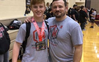 Midwest Wrestling Regional Training Center Coach Chris Fleeger with club wrestlers at Indiana Freestyle States