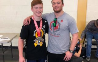 Midwest Wrestling Regional Training Center Coach Josh Harper with club wrestlers at Indiana Freestyle States