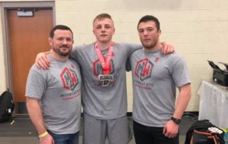 Midwest Wrestling Regional Training Center Coaches Chris Fleeger and Josh Harper with Their Wrestlers at Freestyle States